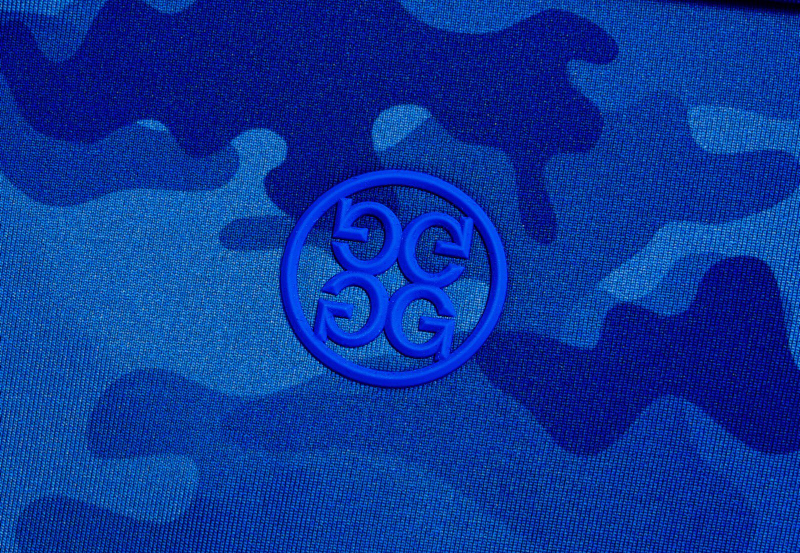 A circle G icon embroidered on a patterned blue camo fabric.